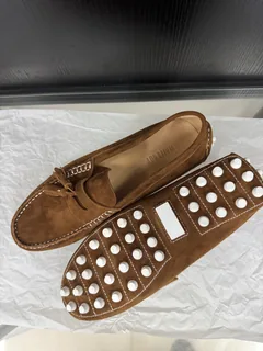 Women's suede loafer outsole detail showing the full-wrap sole construction