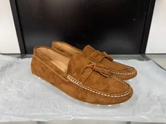 Women's brown suede tassel loafers with full-wrap sole, angled view
