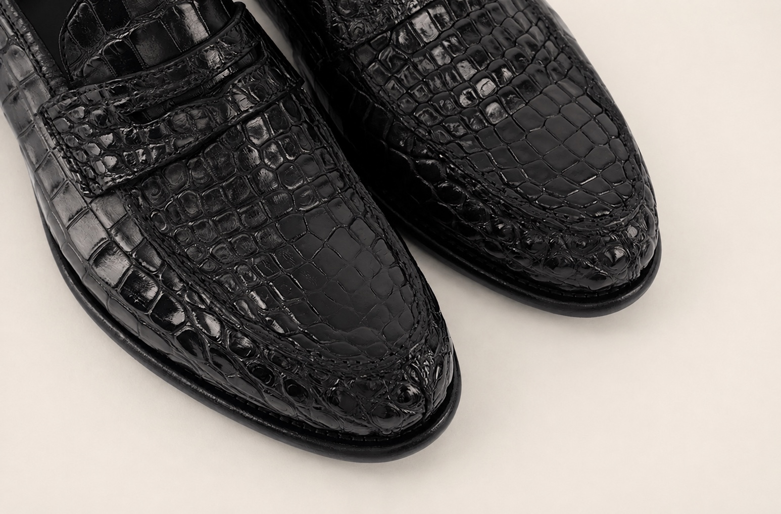 Close-up of the black crocodile vamps and penny straps