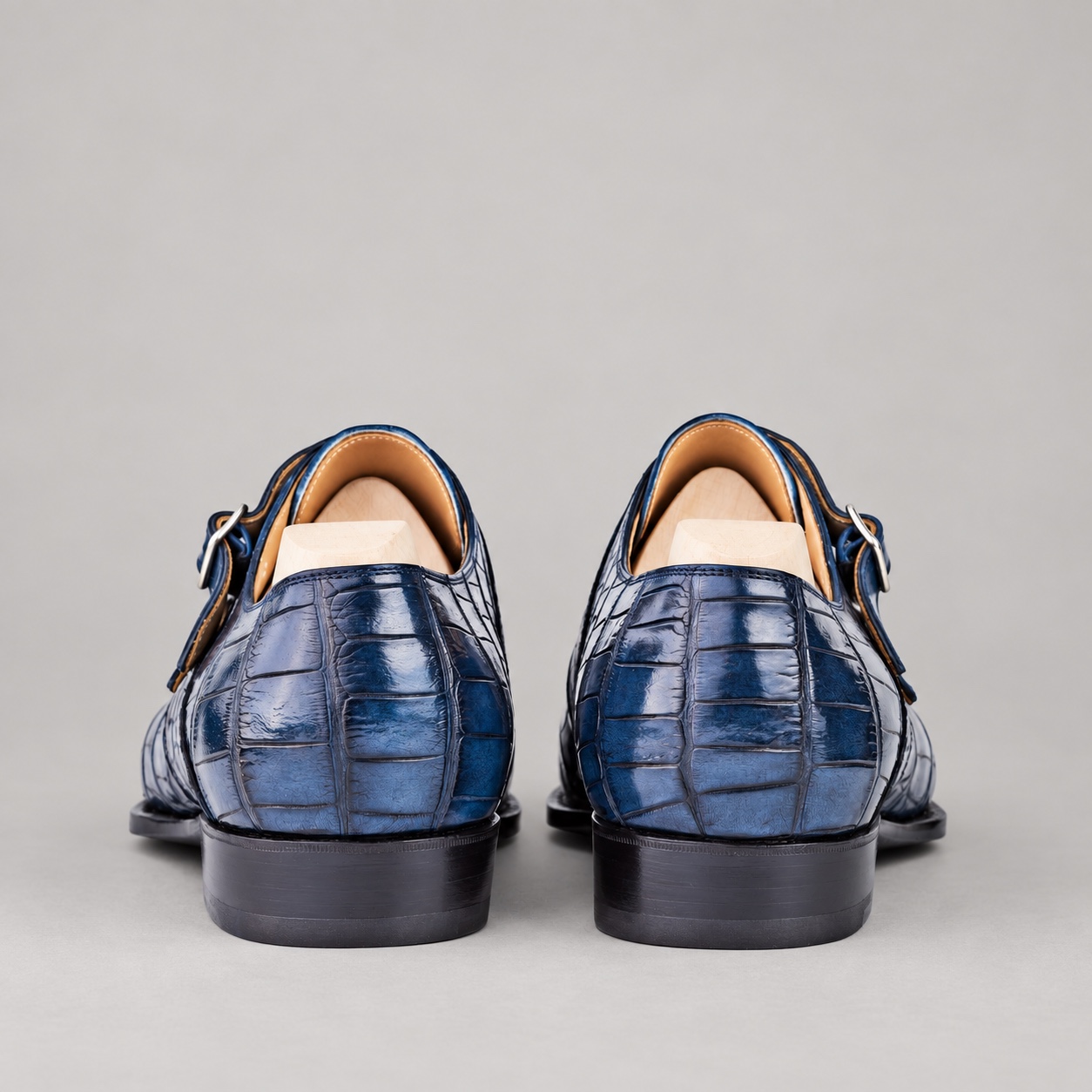 Rear view of blue alligator double monk strap shoes with plain tan cowhide lining
