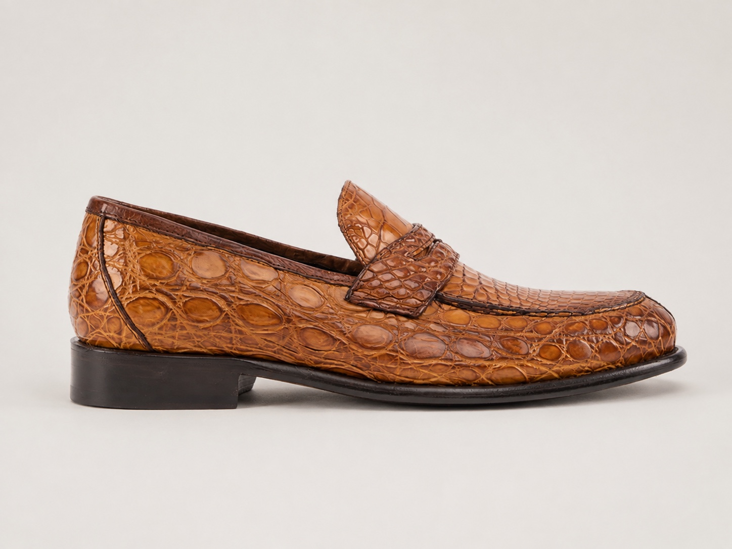 Side profile of the brick brown crocodile penny loafer