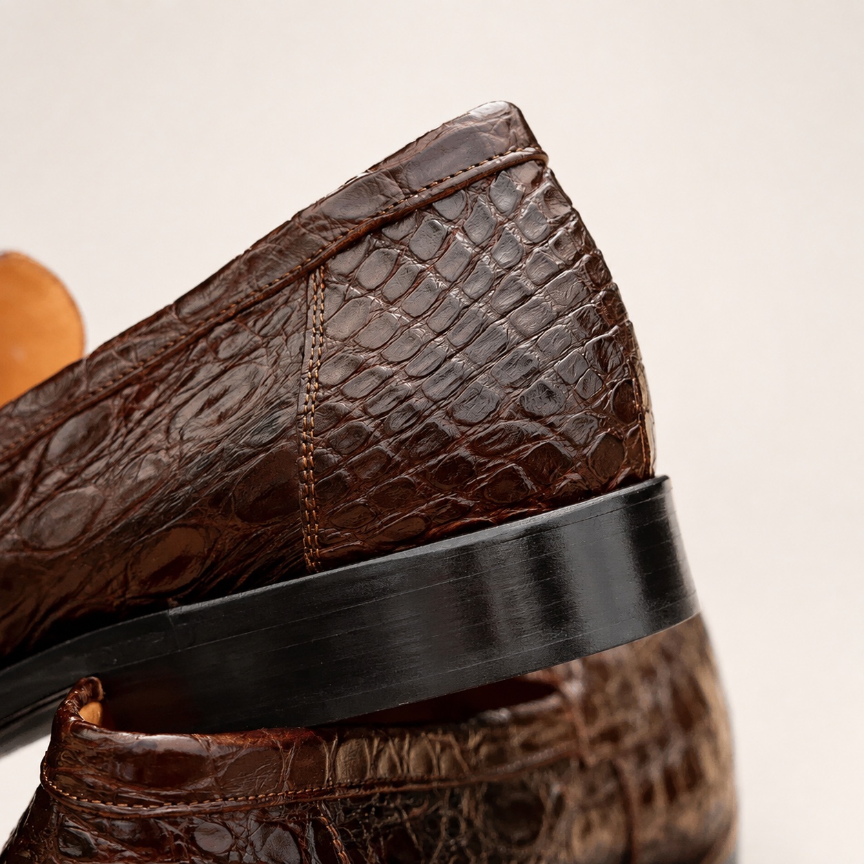 Cognac crocodile penny loafer heel and rear stitching detail