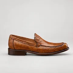 Side profile of a mahogany alligator loafer with a low heel and brown patina sole edge