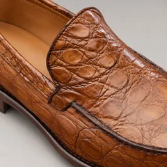 Close-up of the alligator leather texture, apron stitching and unbranded cowhide lining