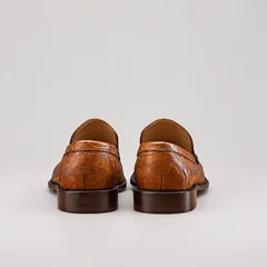 Rear view of mahogany alligator slip-on loafers showing heel seams and brown sole edges
