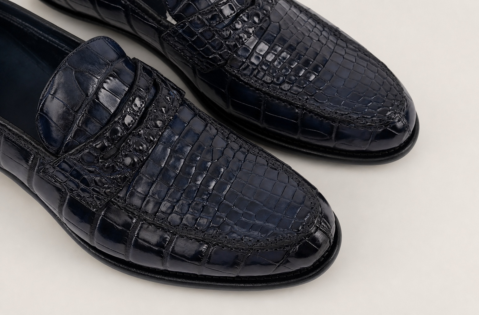 Close-up of the navy blue crocodile vamps and penny straps