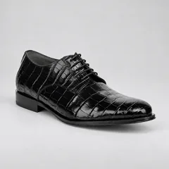 Three-quarter view showing glossy black alligator scales and dark grey cow suede lining
