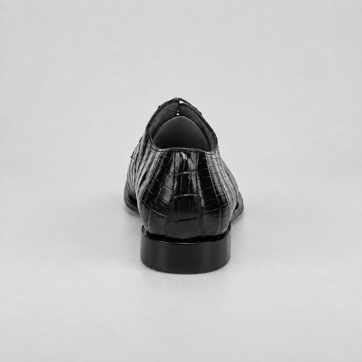 Rear view showing the black alligator heel seam and dark charcoal heel