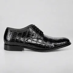 Outer side of a black alligator lace-up shoe with a near-black sole edge