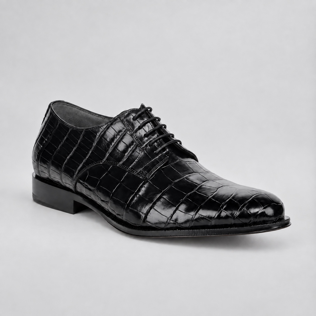 Alternate angle showing the black laces, alligator texture and unbranded dark grey lining