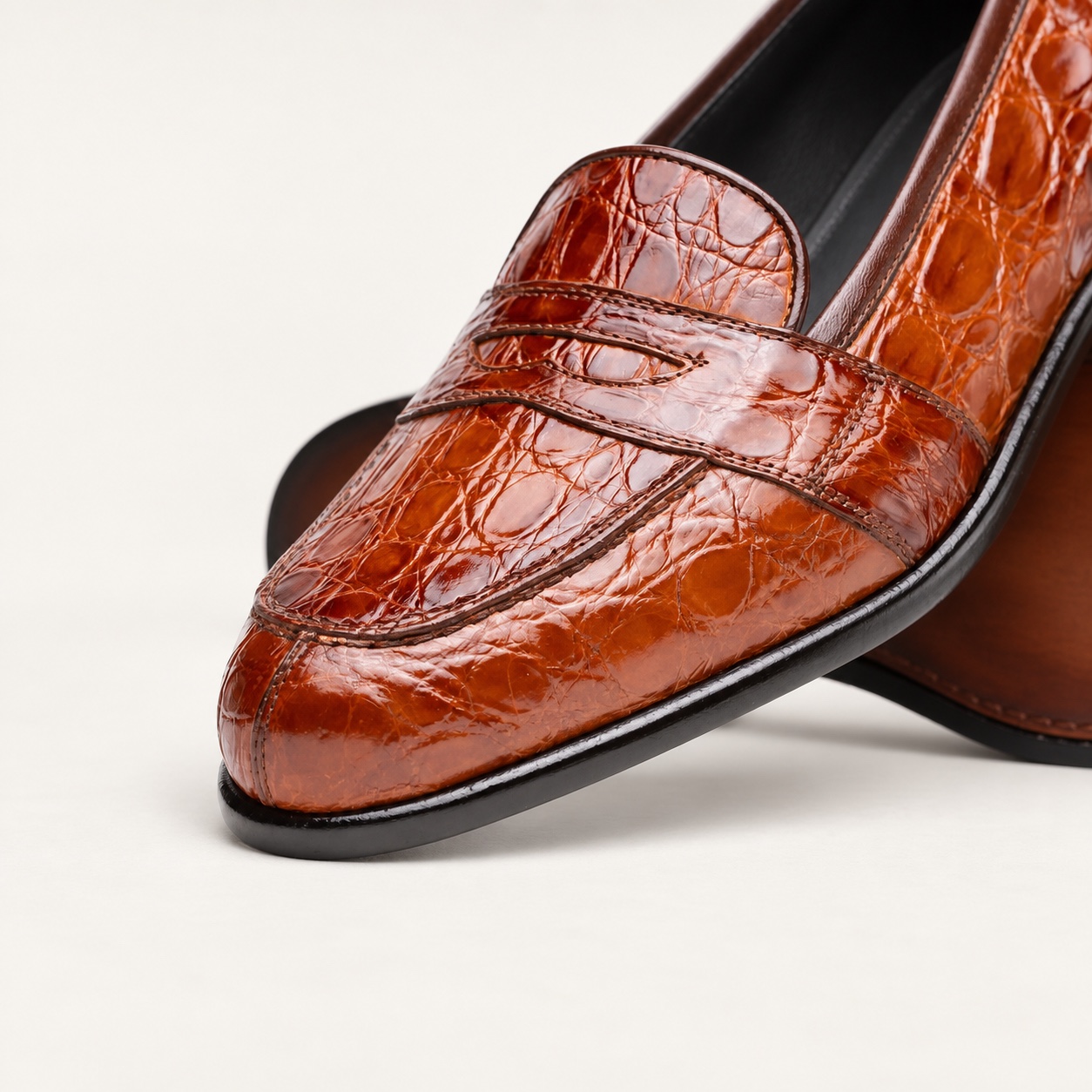 Close-up of the cognac crocodile leather upper and penny strap