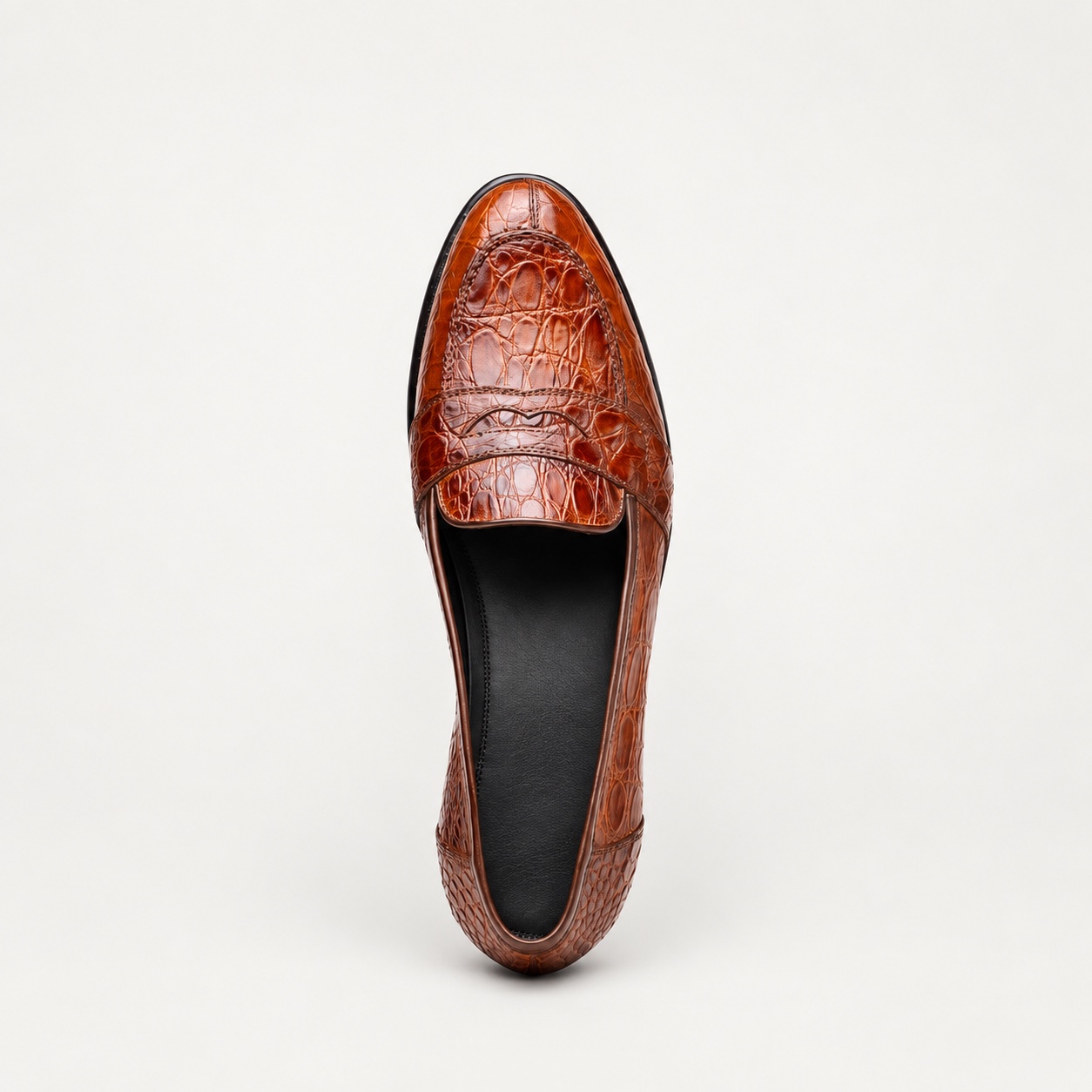 Top view of the cognac penny loafer with unbranded black cowhide lining