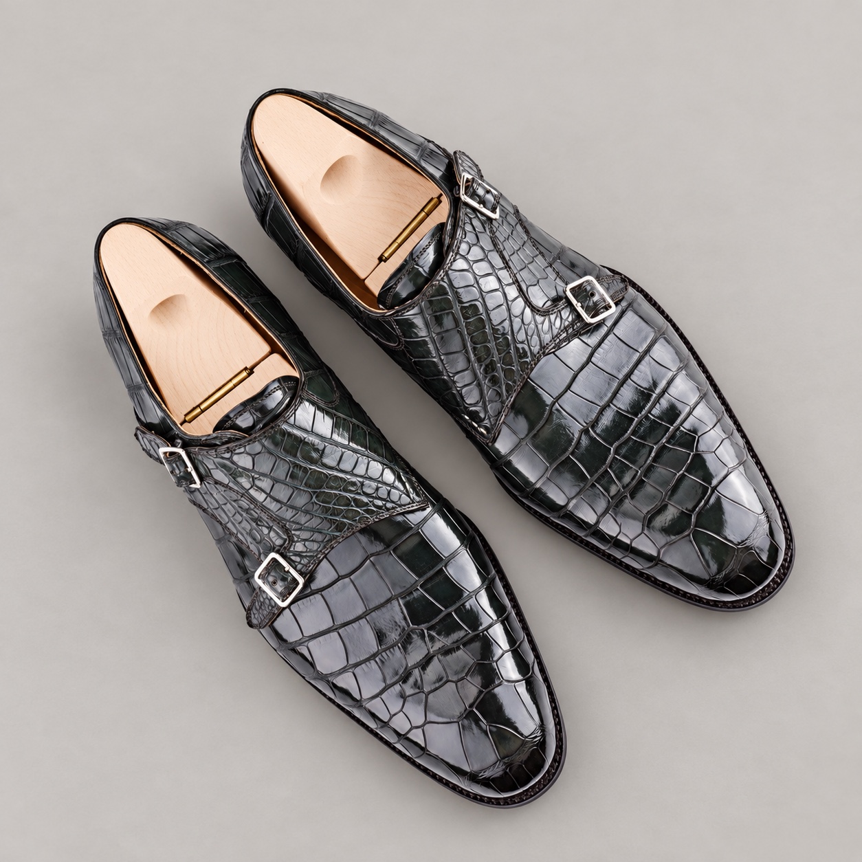 Olive alligator double monk strap shoes with unbranded wooden shoe trees, top view