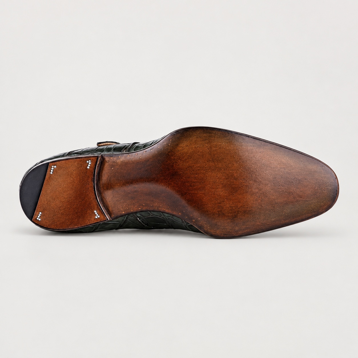 Brown-charcoal burnished sole finish on an olive alligator double monk strap shoe