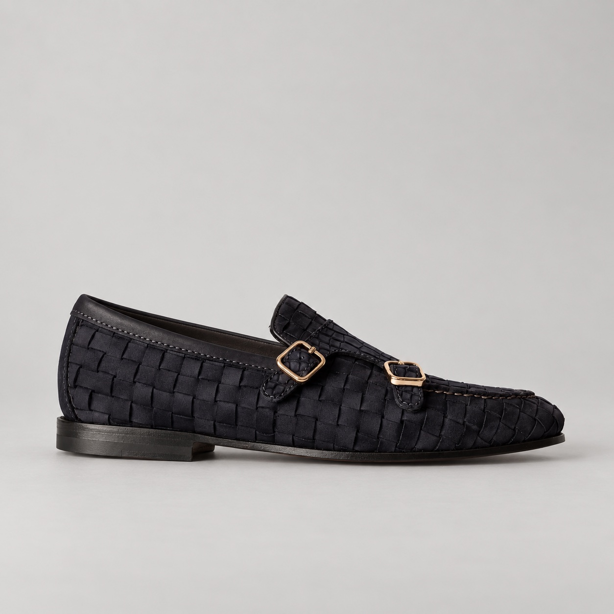 Side view showing woven suede panels and alligator double-buckle straps