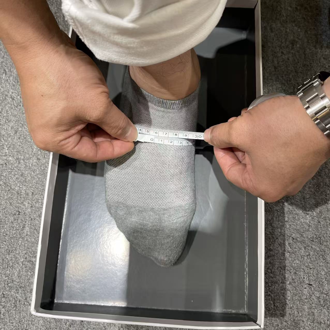 Soft tape positioned around the widest part of the forefoot for a custom shoe ball-girth measurement