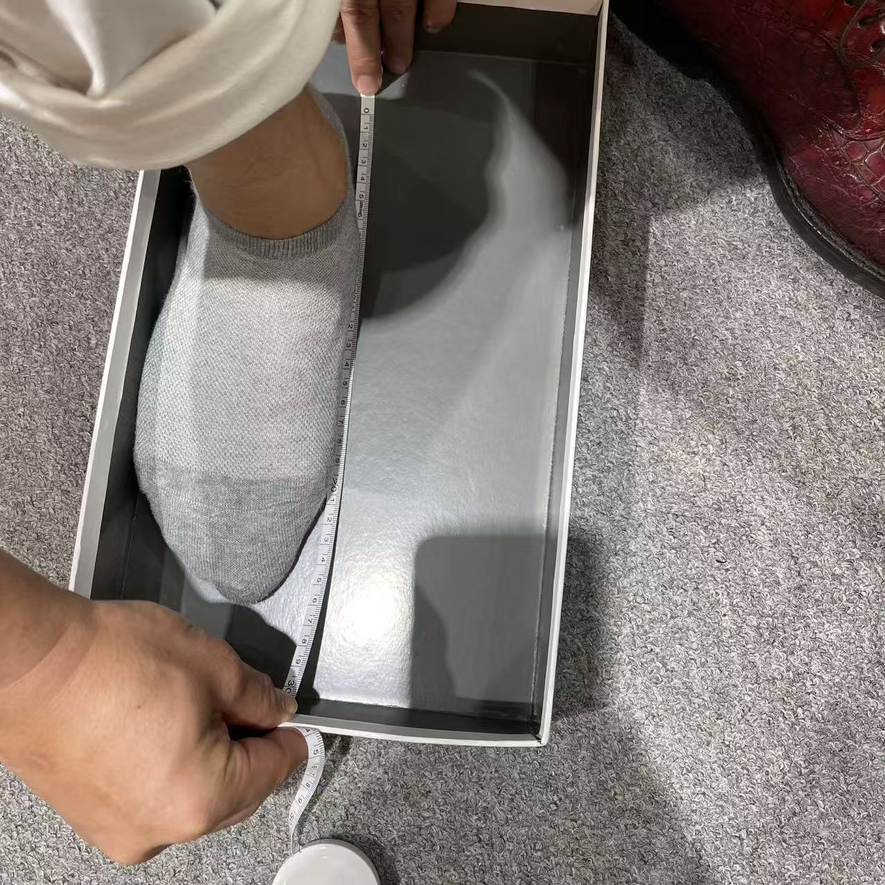 Foot length being measured from the back of the heel to the longest toe while standing